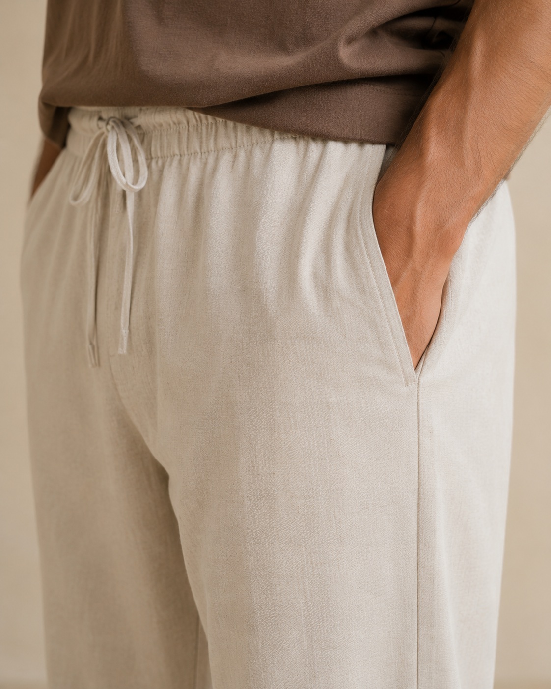 Close-up of side pocket, drawcord waist and textured cream cotton linen fabric