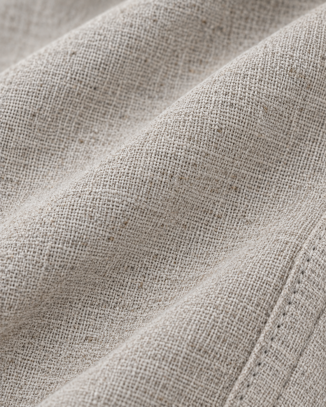 Macro view of the textured grey linen cotton fabric used in the pajama pants