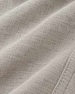 Macro view of the textured grey linen cotton fabric used in the pajama pants
