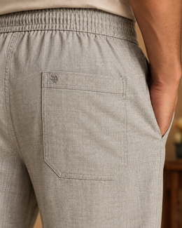Close-up of grey linen cotton pajama pants back patch pocket with tonal SA embroidery