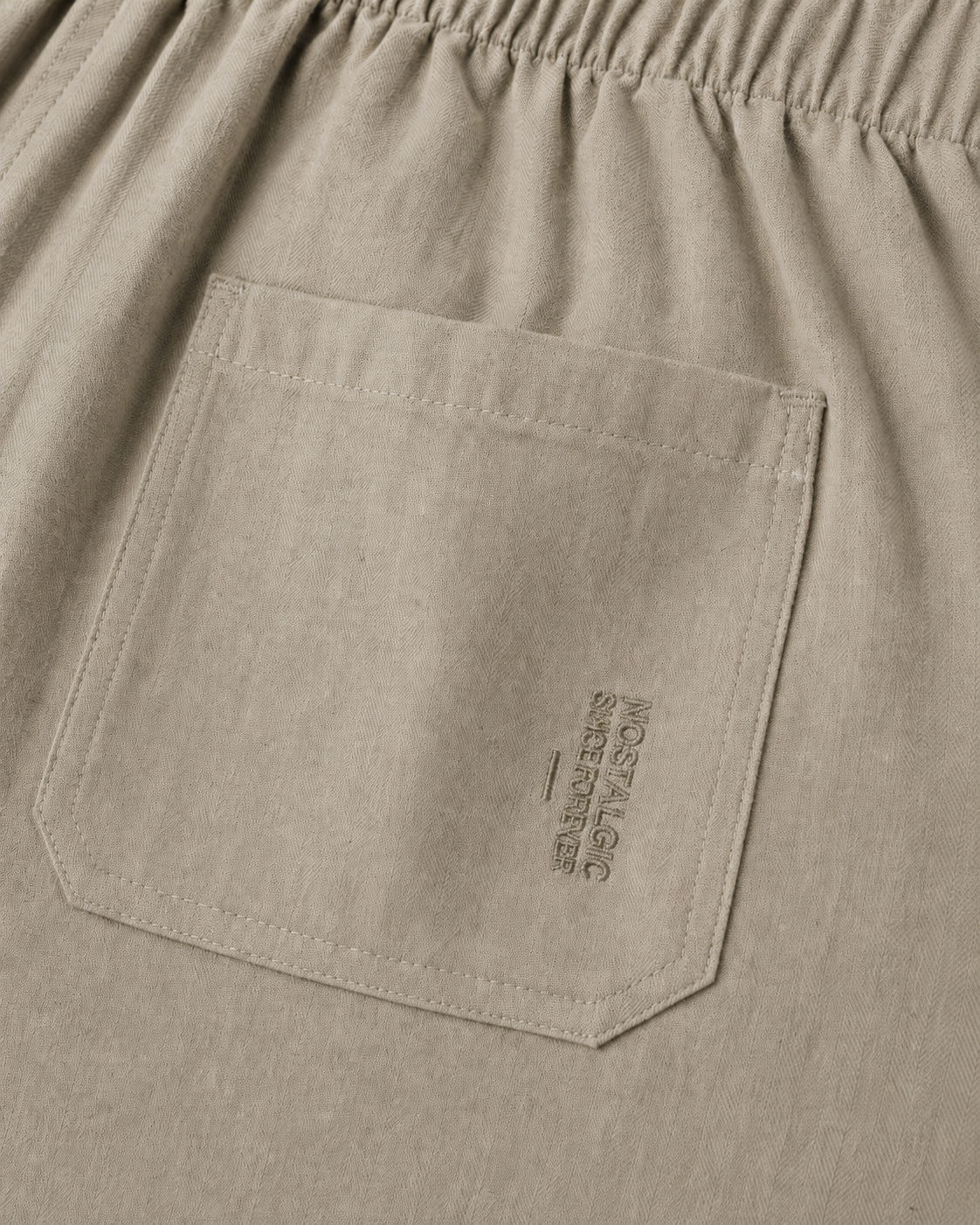 Close-up of back patch pocket with tonal Nostalgic Since Forever embroidery