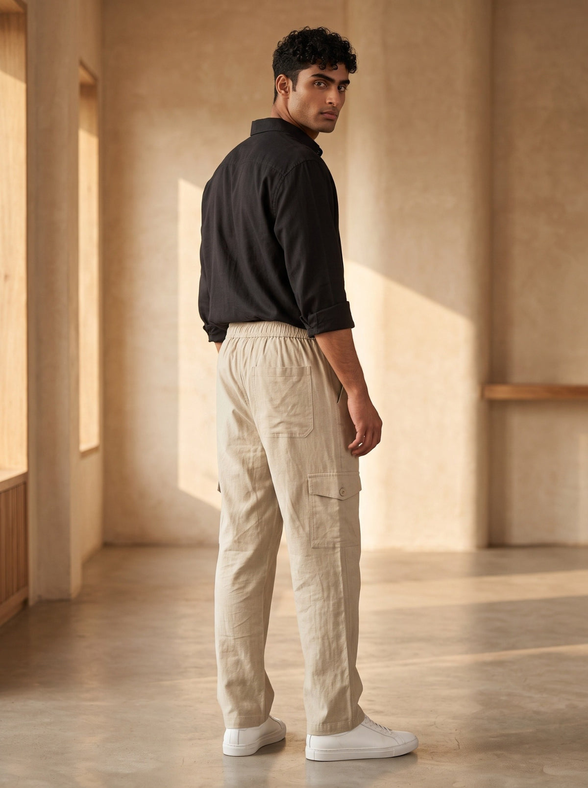 Back view of men’s cream cotton cargo pants with patch pocket and thigh utility pocket