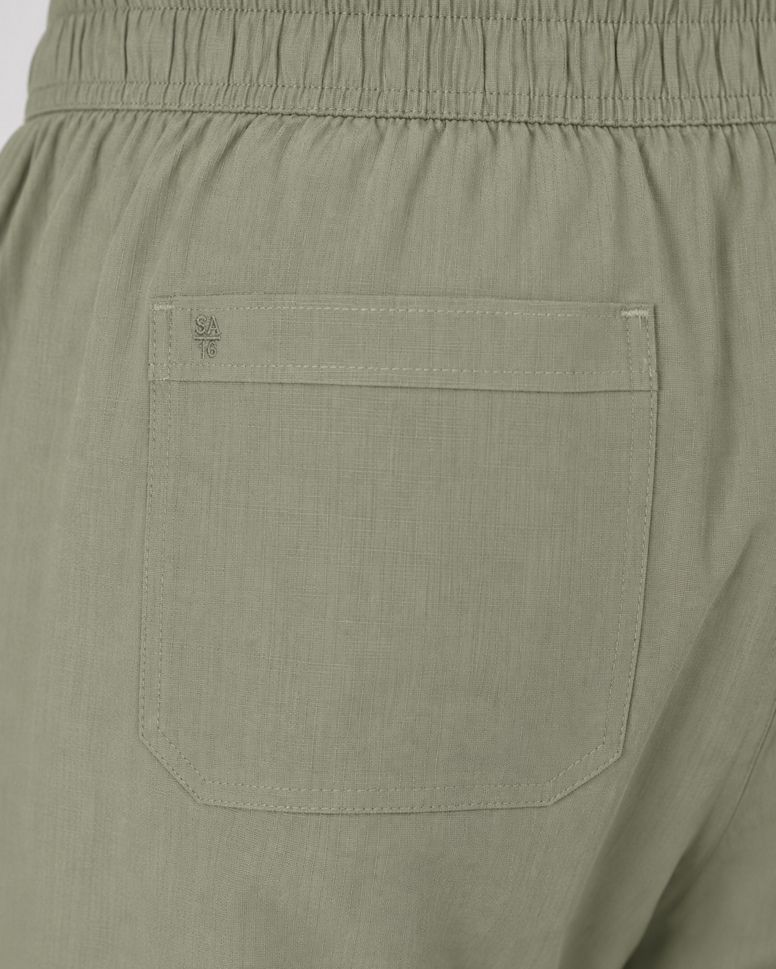 Close-up of Pista pants back patch pocket with tonal SA 16 embroidery